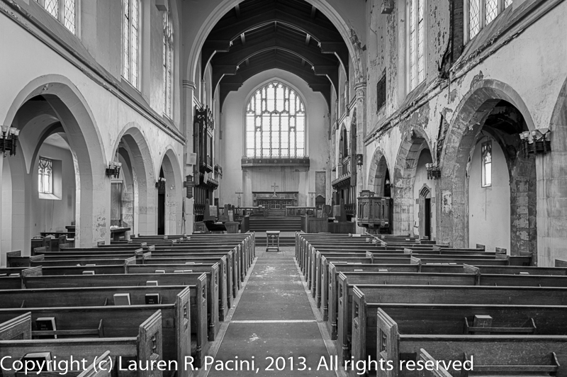 Note damage caused by leaking roof. Hymnals and Bibles remain in the pew racks.